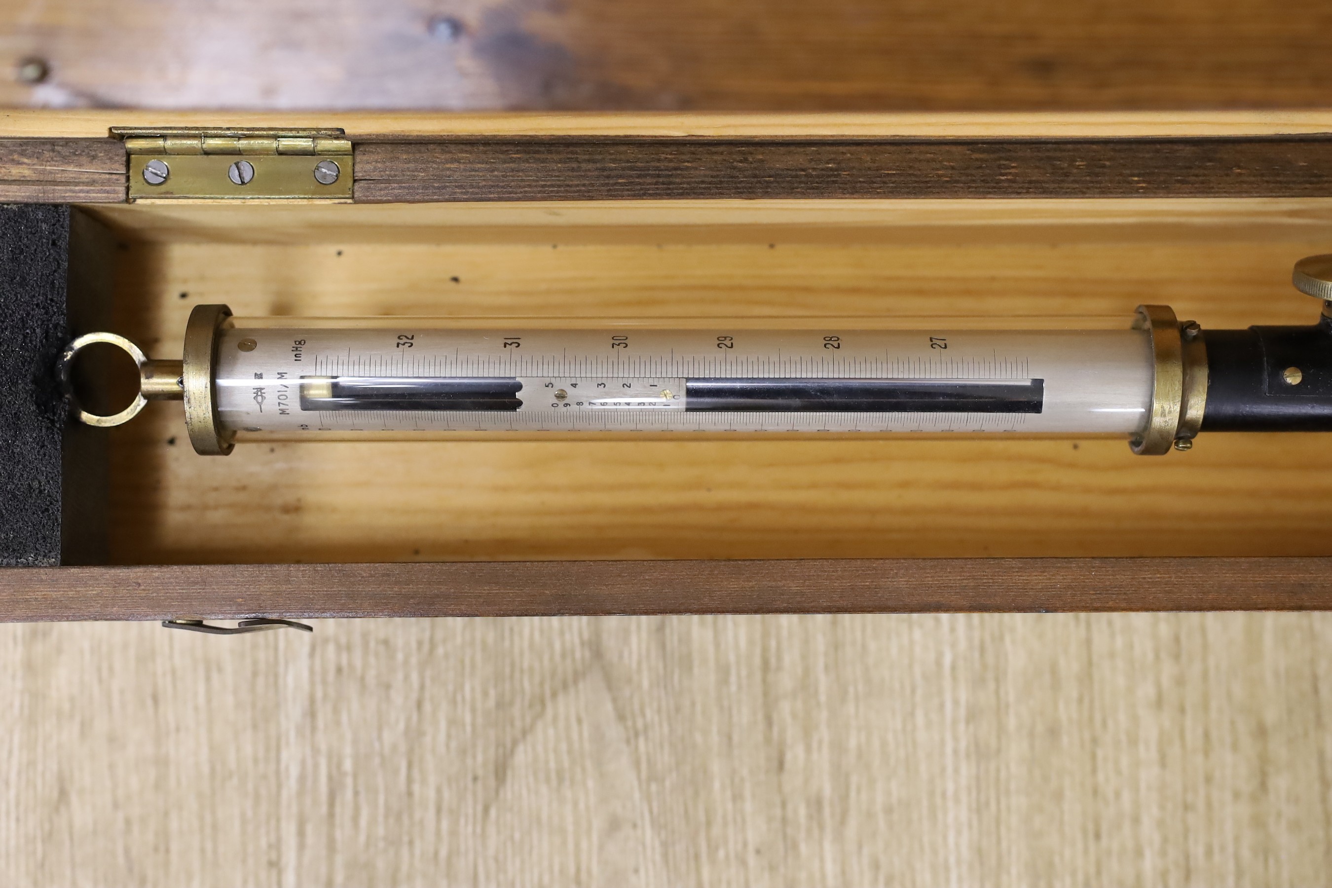 A 20th century marine barometer in a pine case, barometer 39 cms long